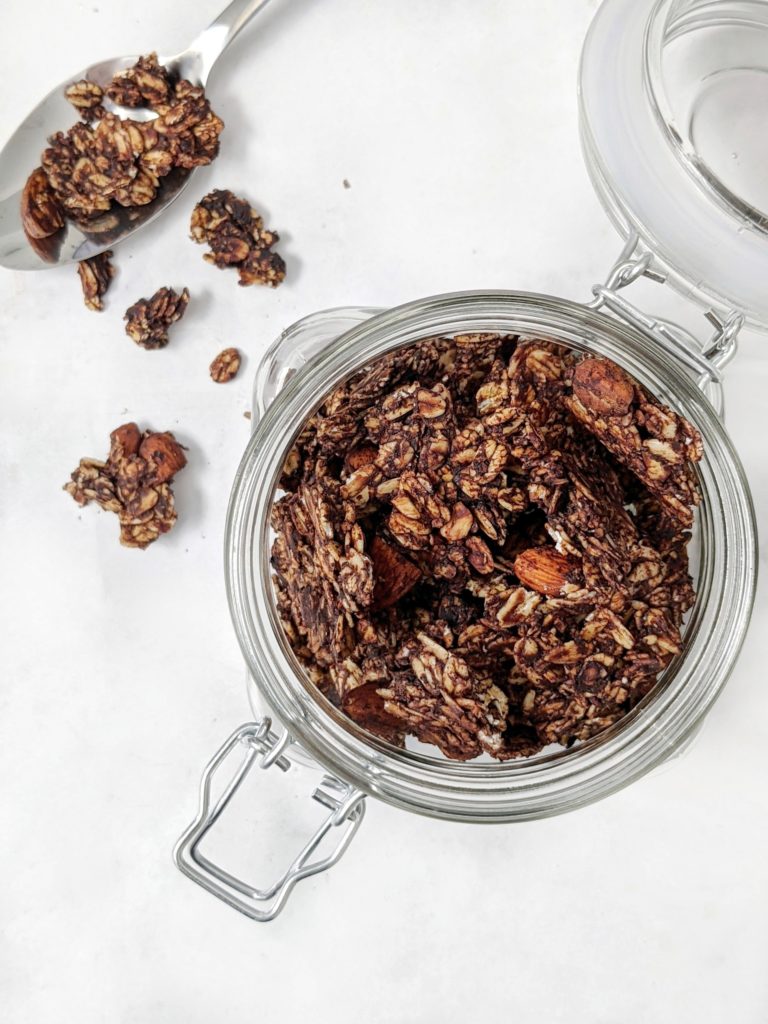 A healthy, but absolutely delicious Dark Chocolate Almond Granola with the perfect clusters. Naturally sweetened and made with cocoa powder and a bit of coconut oil, it’s a low fat and sugar free treat that’s great for breakfast, a snack or even dessert!