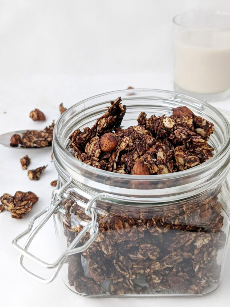 A crunchy vegan homemade chocolate almond granola with shredded coconut or coconut flakes that’s a perfect breakfast cereal, snack clusters or even dessert bark.