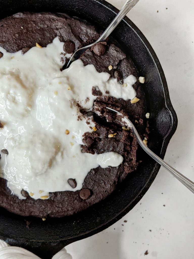 Easy and healthy double chocolate brownies made in one bowl with melted dark chocolate and cocoa powder, poured in a skillet and topped with more chocolate chips.