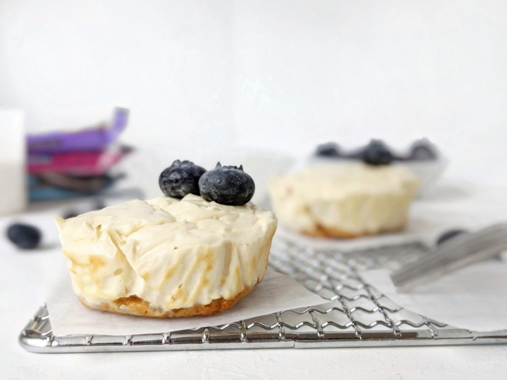 Mini Protein Cheesecakes with a Protein Bar Crust - easy, healthy, high protein cheesecake bites made with greek yogurt and protein powder, and a protein bar for the crust! These mini cheesecakes are made in a muffin tin and perfect for a single serve or small batch baking. Gluten-free and sugar-free too!