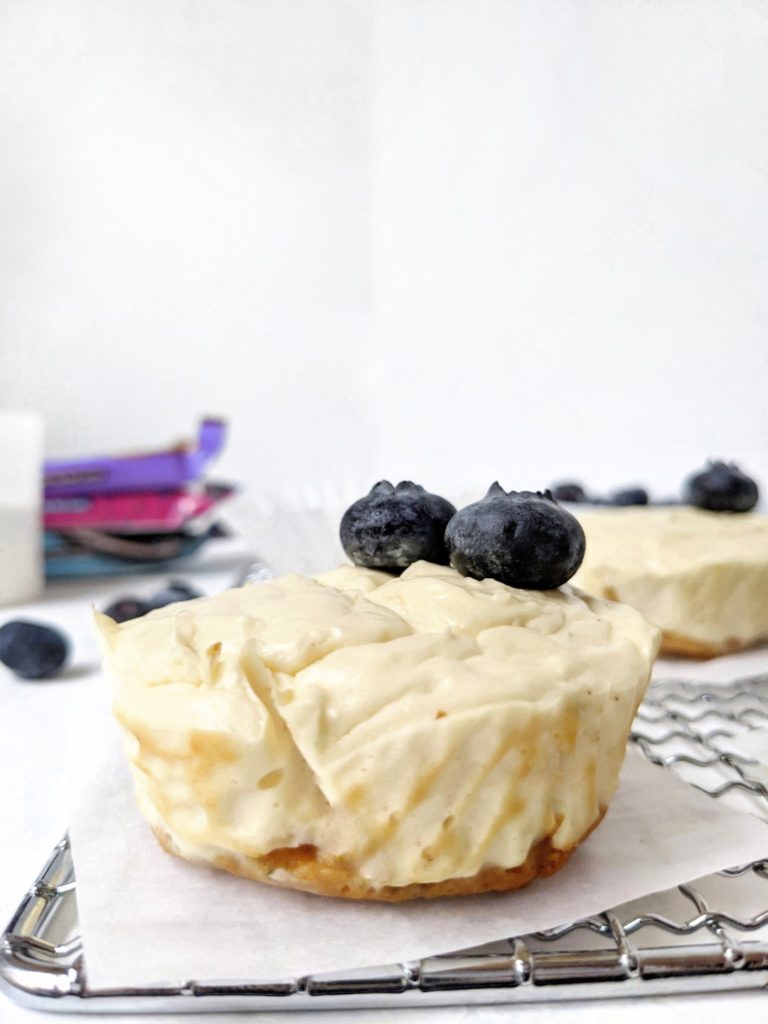 Mini Protein Cheesecakes with a Protein Bar Crust - easy, healthy, high protein cheesecake bites made with greek yogurt and protein powder, and a protein bar for the crust! These mini cheesecakes are made in a muffin tin and perfect for a single serve or small batch baking. Gluten-free and sugar-free too!