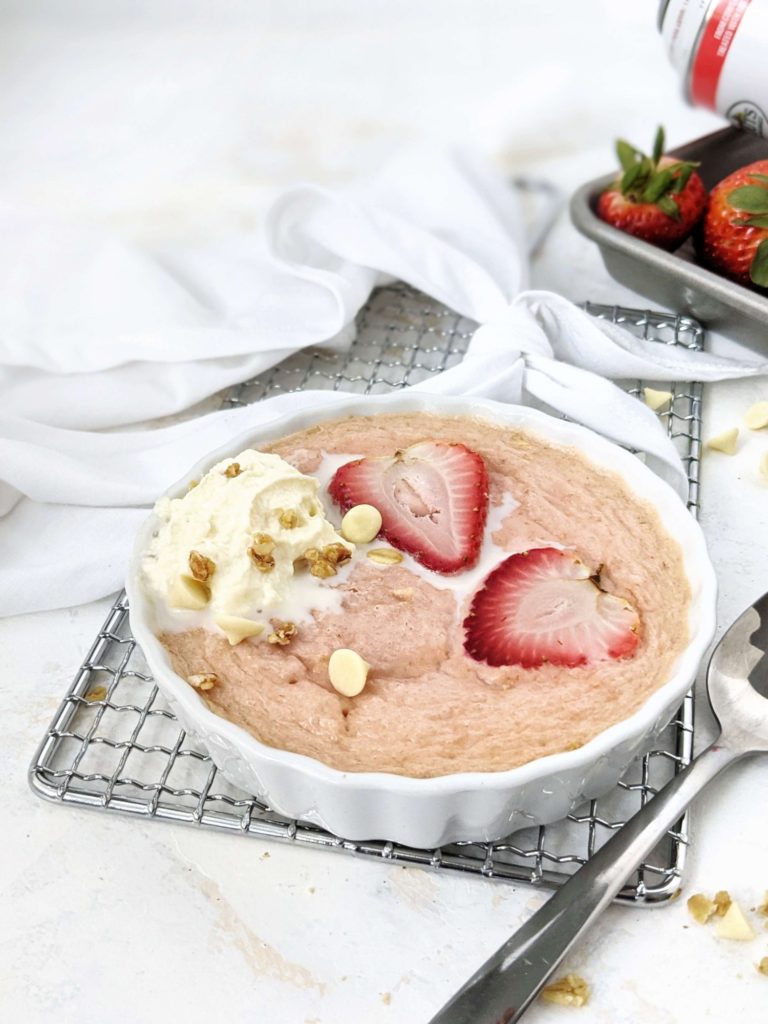 A high protein Strawberry Baked Oatmeal for One: Sweetened with protein powder and made creamy with greek yogurt, this strawberry protein baked oats is a healthy breakfast recipe that tastes just like a strawberries and cream dessert!