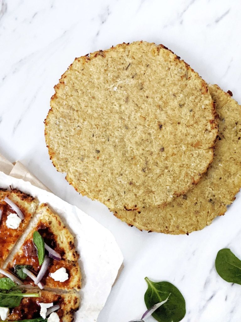 A healthy, low calorie and high protein Cauliflower Chicken Crust Pizza. With no flour and packed with chicken, this is a perfect gluten free, low carb, keto protein pizza crust for all your favorite toppings.