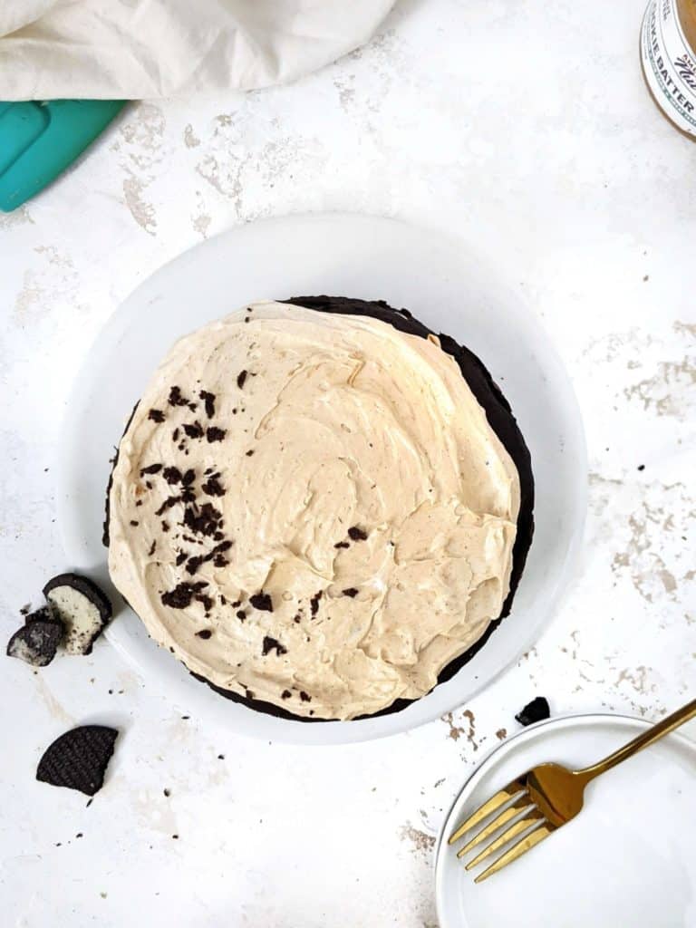 An irresistible Oreo Protein Cake topped with a Peanut Butter frosting for the cookies and cream flavor with a bonus. This simple protein cake uses chocolate protein powder, is sugar-free and has very little butter; Definitely better than other recipes out there!