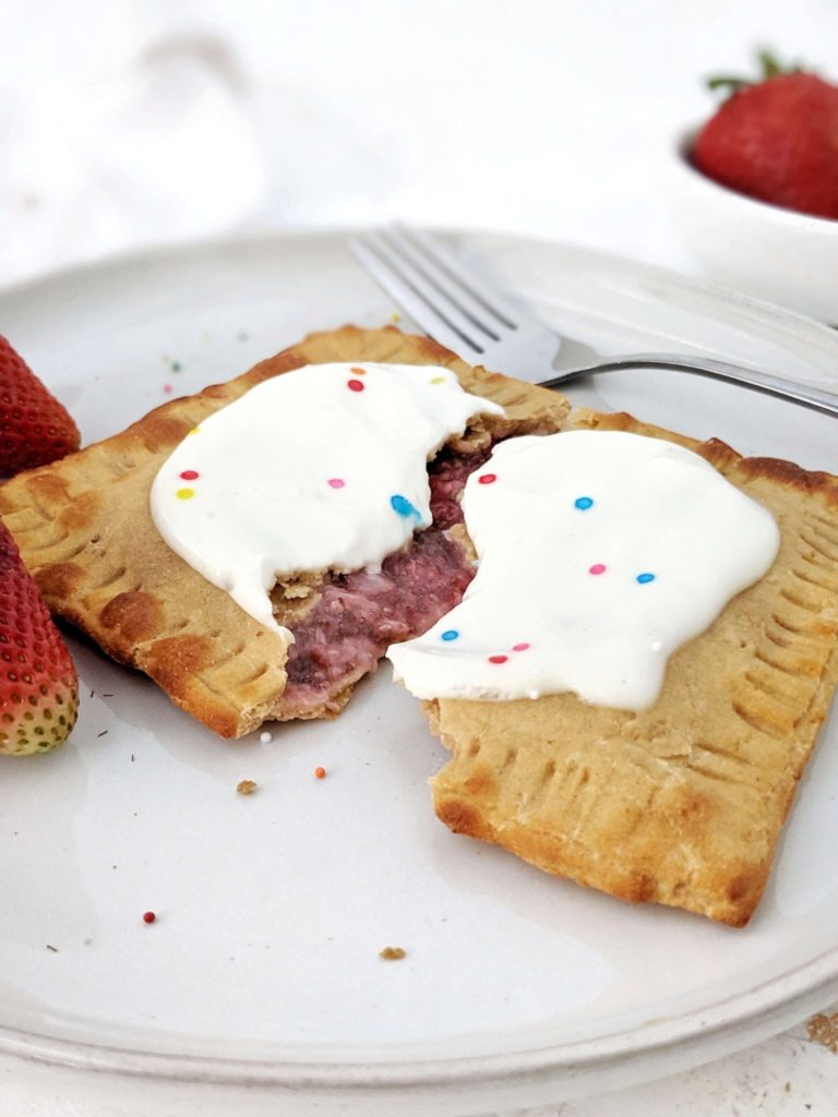 A big single serve Healthy Protein Pop Tarts made with a gluten free base, filled with homemade strawberry jam and topped with high protein sugar free frosting; Vegan too. An easy protein powder poptart made in the air fryer - or baked - to satisfy the sugar cravings.