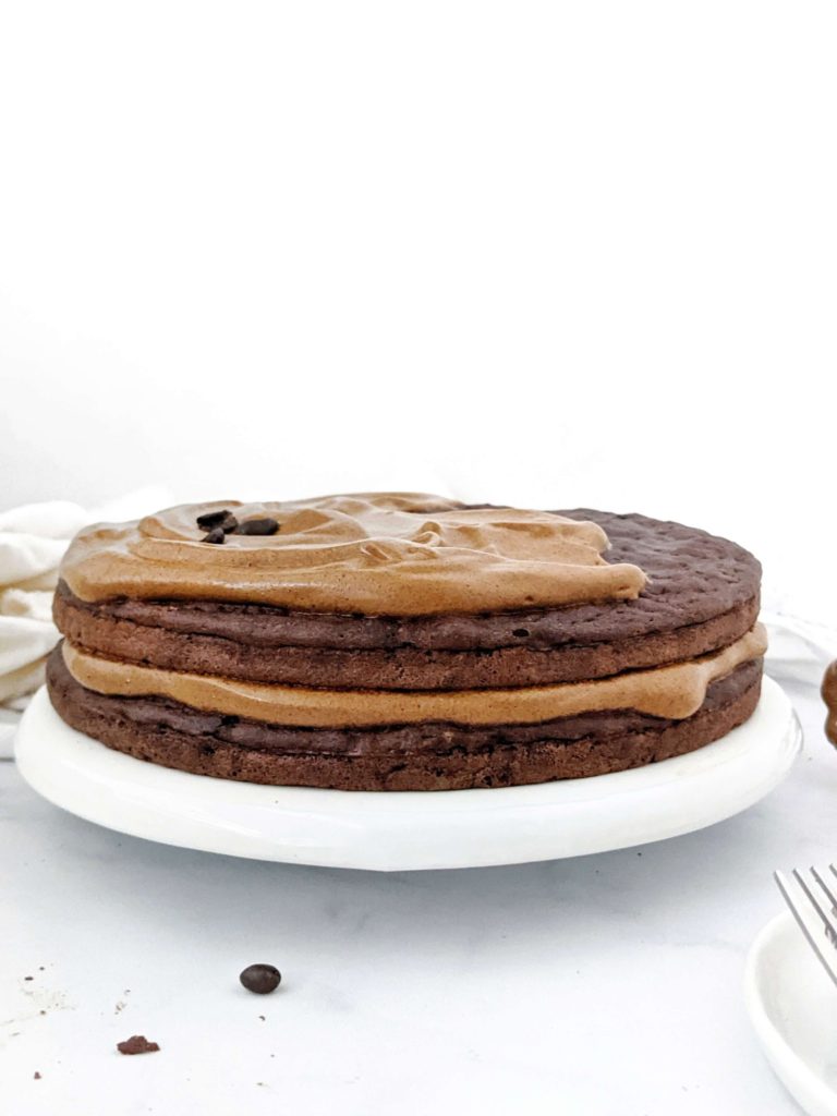 A rich Mocha Protein Cake topped with a Protein Dalgona Coffee Frosting! An easy, healthy and low calorie Chocolate Coffee Protein Cake made with whole wheat, Greek Yogurt and sweetened with protein powder. The perfect protein packed dessert with a caffeine bump and chocolate taste in one!