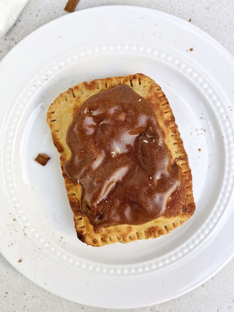 Easy and healthy Brown Sugar Cinnamon Protein Pop Tarts but actually sugar free! This high protein pop tart uses protein powder in the dough, brown sugar cinnamon filling and frosting too.