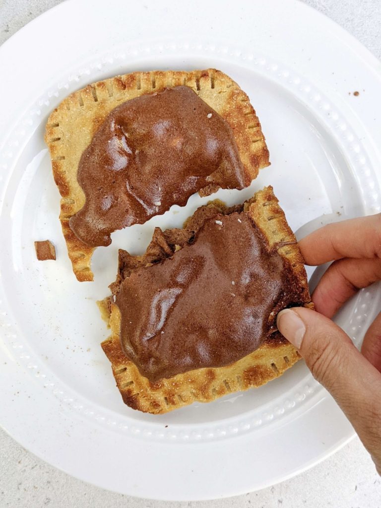 Easy and healthy Brown Sugar Cinnamon Protein Pop Tarts but actually sugar free! This high protein pop tart uses protein powder in the dough, brown sugar cinnamon filling and frosting too.