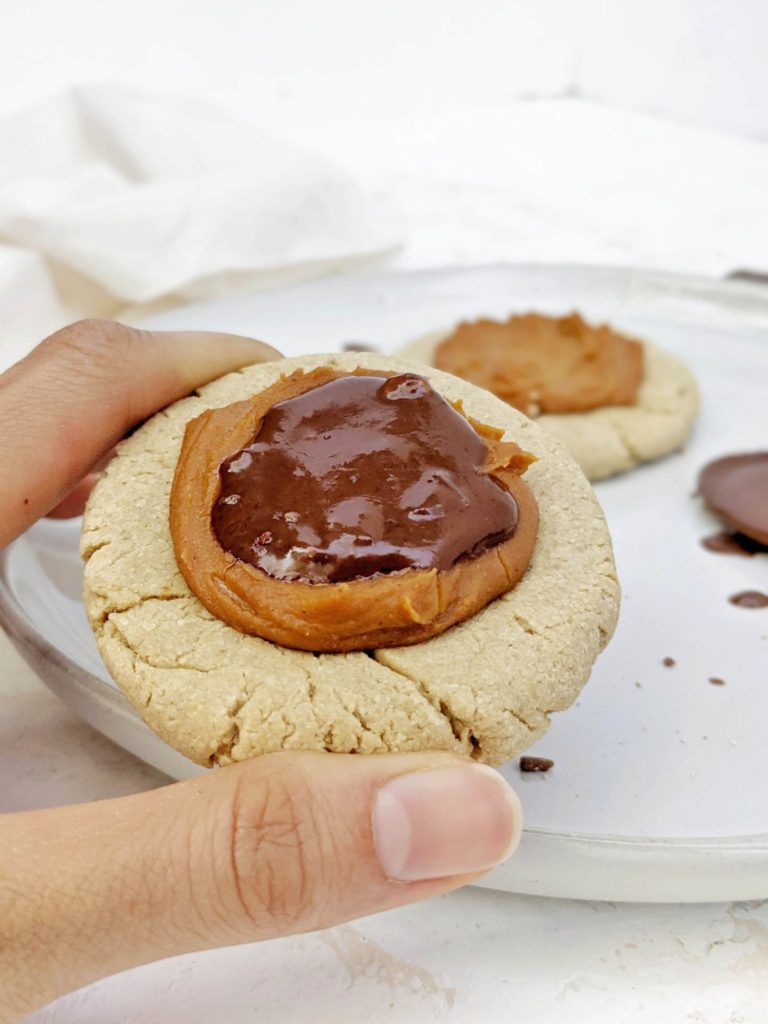 Beautiful Crumbl inspired Twix Protein Cookies made with a vegan and gluten free cookie, peanut butter protein caramel and sugar free chocolate. A copycat Crumbl Twix cookie at home, but healthy and high protein!