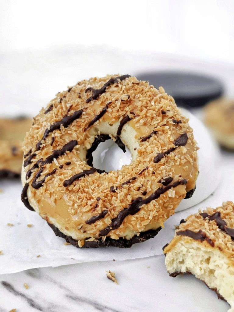 Unbelievably realistic copycat Samoa Protein Donuts with a protein powder doughnut, peanut butter caramel glaze, shredded coconut and sugar free chocolate. Girl scout Samoa cookie inspired protein donuts are healthy, sugar free and low calorie too!