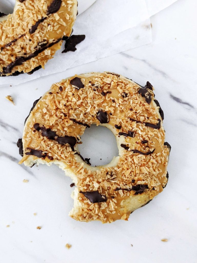 Unbelievably realistic copycat Samoa Protein Donuts with a protein powder doughnut, peanut butter caramel glaze, shredded coconut and sugar free chocolate. Girl scout Samoa cookie inspired protein donuts are healthy, sugar free and low calorie too!