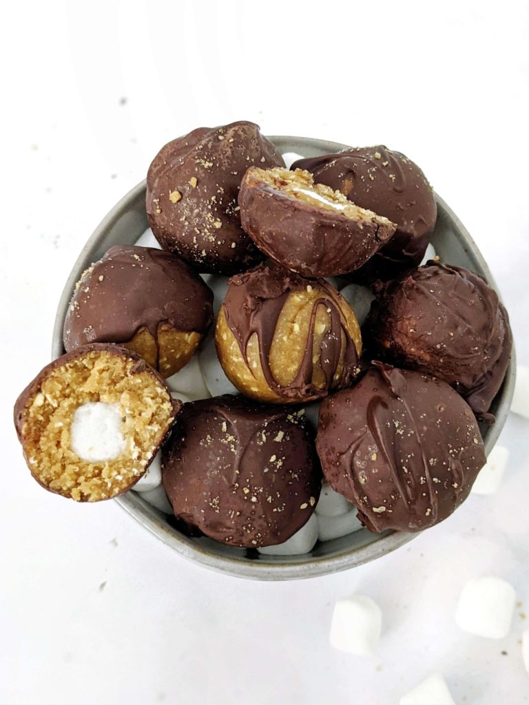 These S’mores Protein Balls are made with graham crackers and marshmallows like a real s'mores desserts, but made healthy with protein powder, collagen and oats! S’mores protein bites are perfect for a snack, dessert or midday energy boost.