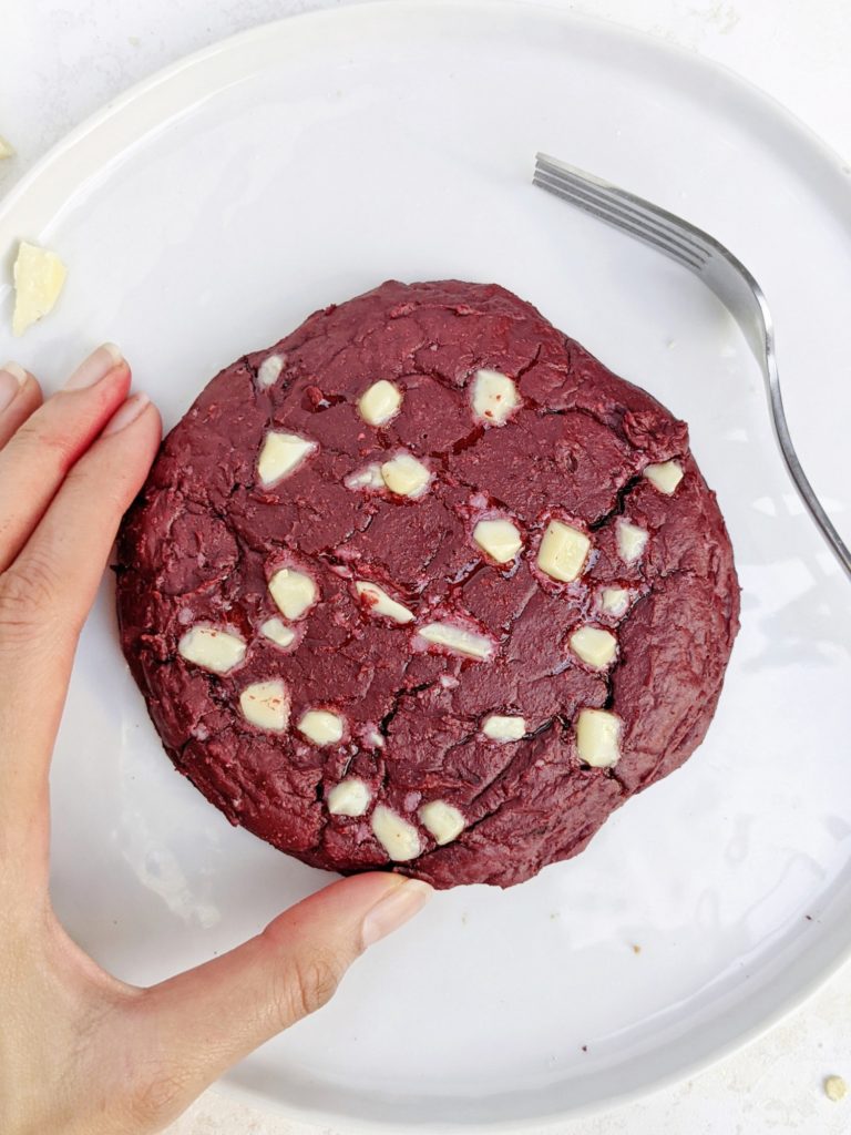 An indulgent single serve Cheesecake Stuffed Red Velvet Protein Cookie - A red velvet protein powder cookie with a protein cheesecake filling. This protein red velvet cheesecake cookie is gluten free, sugar free, has no egg and can be made Vegan too; The perfect protein dessert!