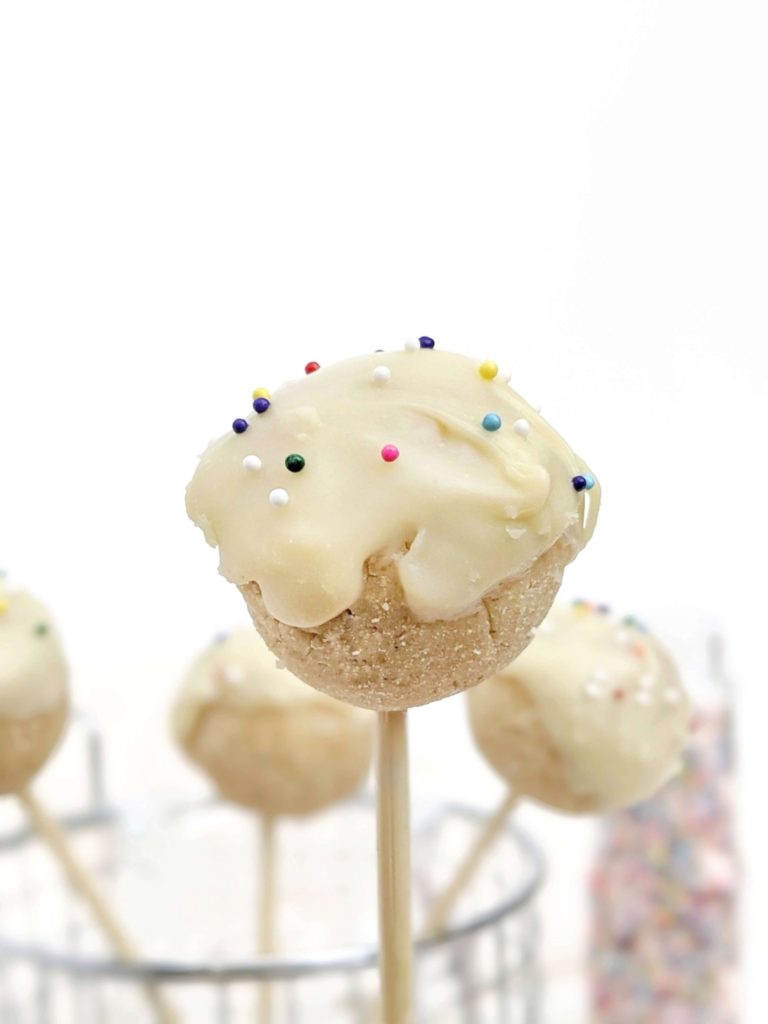 Kinda pretty but still healthy Protein Cake Pops made with just 4 ingredients, and no bake too! These low calorie high protein cake bites are Vegan, gluten free and sugar free; A great birthday cake protein snack or dessert recipe.