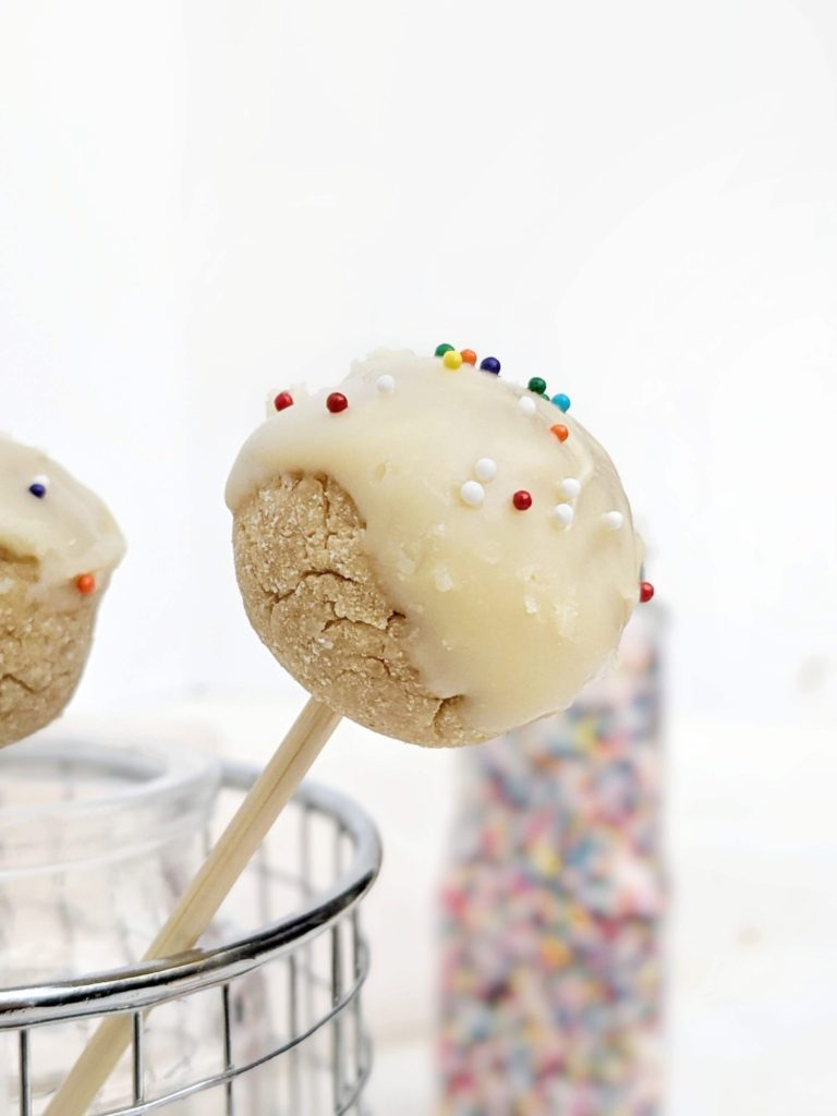 Kinda pretty but still healthy Protein Cake Pops made with just 4 ingredients, and no bake too! These low calorie high protein cake bites are Vegan, gluten free and sugar free; A great birthday cake protein snack or dessert recipe.