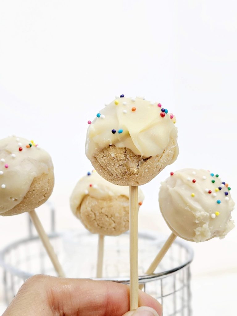 Kinda pretty but still healthy Protein Cake Pops made with just 4 ingredients, and no bake too! These low calorie high protein cake bites are Vegan, gluten free and sugar free; A great birthday cake protein snack or dessert recipe.