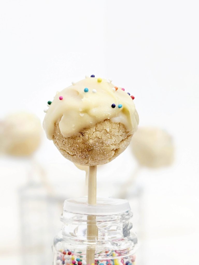 Kinda pretty but still healthy Protein Cake Pops made with just 4 ingredients, and no bake too! These low calorie high protein cake bites are Vegan, gluten free and sugar free; A great birthday cake protein snack or dessert recipe.