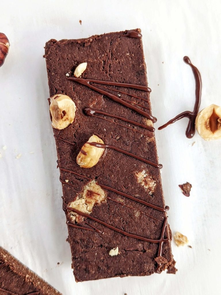 Healthy Nutella Protein Bars inspired by the Ferrero Rocher candy, but sugar free! These Chocolate Hazelnut Protein Bars use a sugar free chocolate nut butter spread and are sweetened with protein powder for a rich chocolate fudge flavor.