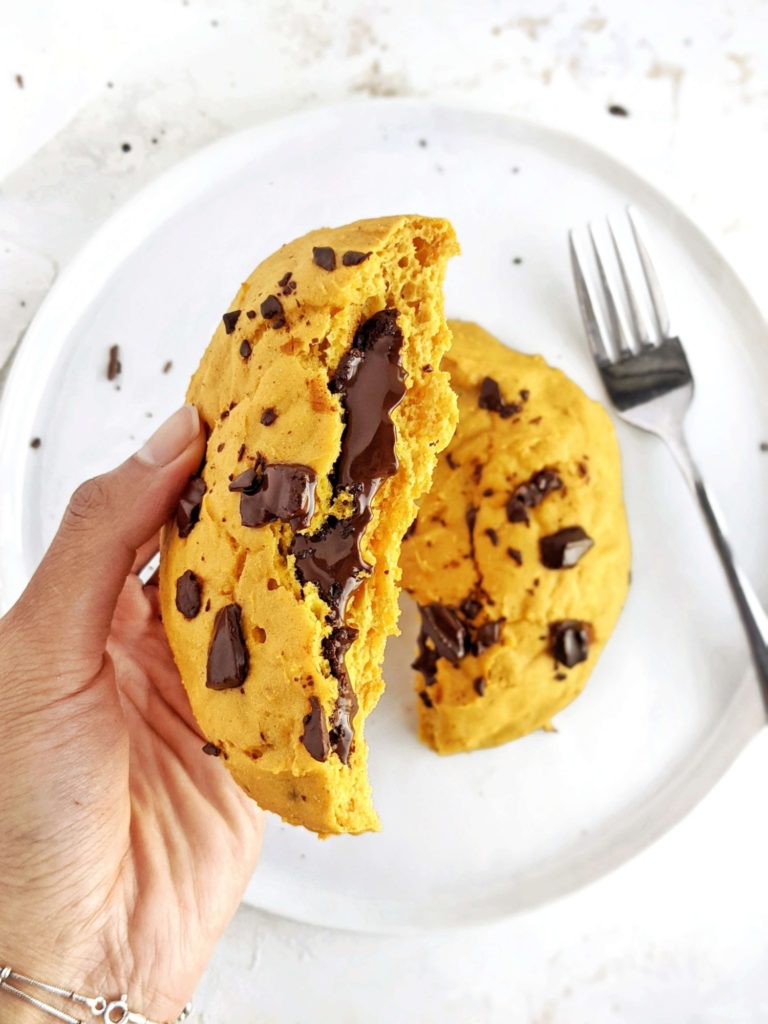 A ginormous Chocolate Lava Pumpkin Protein Cookie for One with a gooey molten chocolate center. This healthy single serve pumpkin protein powder cookie is gluten free, vegan and sugar free; A perfect pumpkin protein dessert.