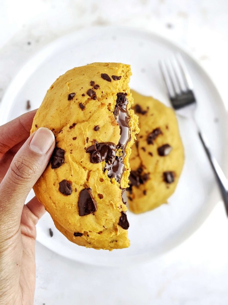 A ginormous Chocolate Lava Pumpkin Protein Cookie for One with a gooey molten chocolate center. This healthy single serve pumpkin protein powder cookie is gluten free, vegan and sugar free; A perfect pumpkin protein dessert.