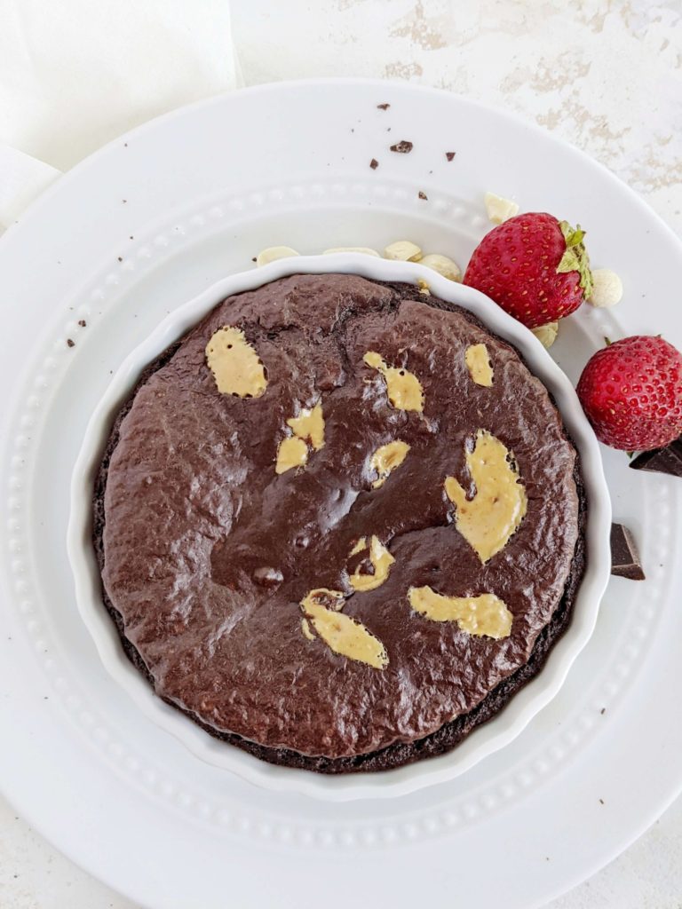 A half baked Peanut Butter Protein Brownie for one with a fudgy gooey center. This healthy peanut butter brownie uses peanut butter powder and protein powder for a rich, single serve dessert.