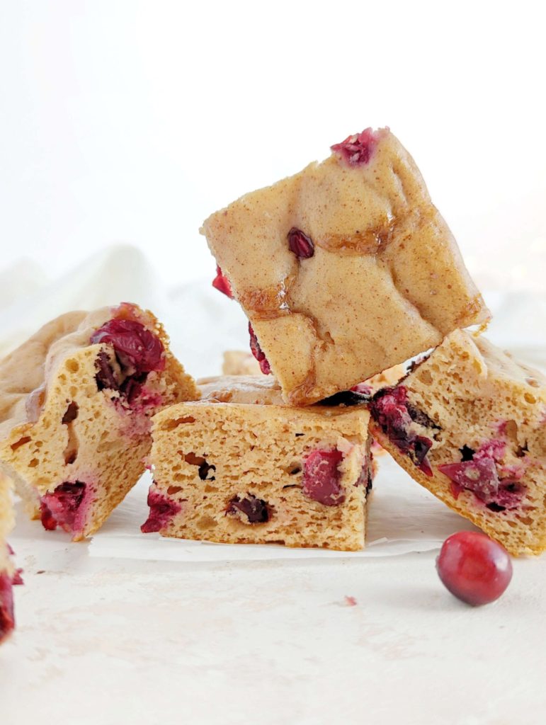 A sweet and tarty Cinnamon Cranberry Protein Cake loaded with fresh cranberries for a great winter dessert recipe! This healthy cranberry cake uses protein powder, monkfruit and Greek yogurt, has no eggs, butter or oil, and is gluten free too. 