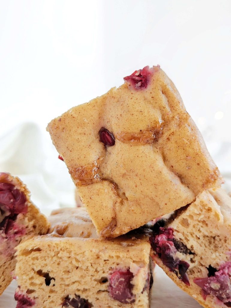 A sweet and tarty Cinnamon Cranberry Protein Cake loaded with fresh cranberries for a great winter dessert recipe! This healthy cranberry cake uses protein powder, monkfruit and Greek yogurt, has no eggs, butter or oil, and is gluten free too. 