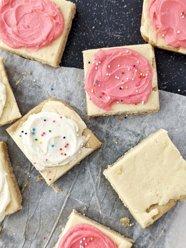 Pretty and perfect frosted Sugar Cookie Protein Bars made with oat flour and protein powder, and actually sugar free! These no bake and heathy sugar cookie protein bars are gluten free and Vegan too.