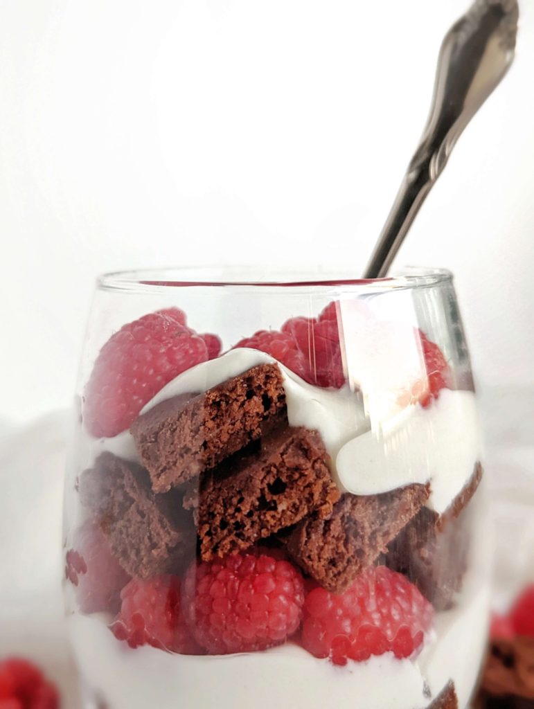 An easy and beautiful Chocolate Raspberry Protein Trifle with protein brownies, a Greek yogurt ‘custard’ and fresh raspberries. This healthy raspberry brownie trifle is sugar free, gluten free and Vegan too!