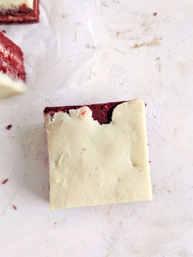 Pretty and perfect Red Velvet Protein Bars complete with layers and a protein cream cheese ‘frosting’! These no bake red velvet bars use protein powder and greek yogurt for a sugar free, low fat and healthy recipe.