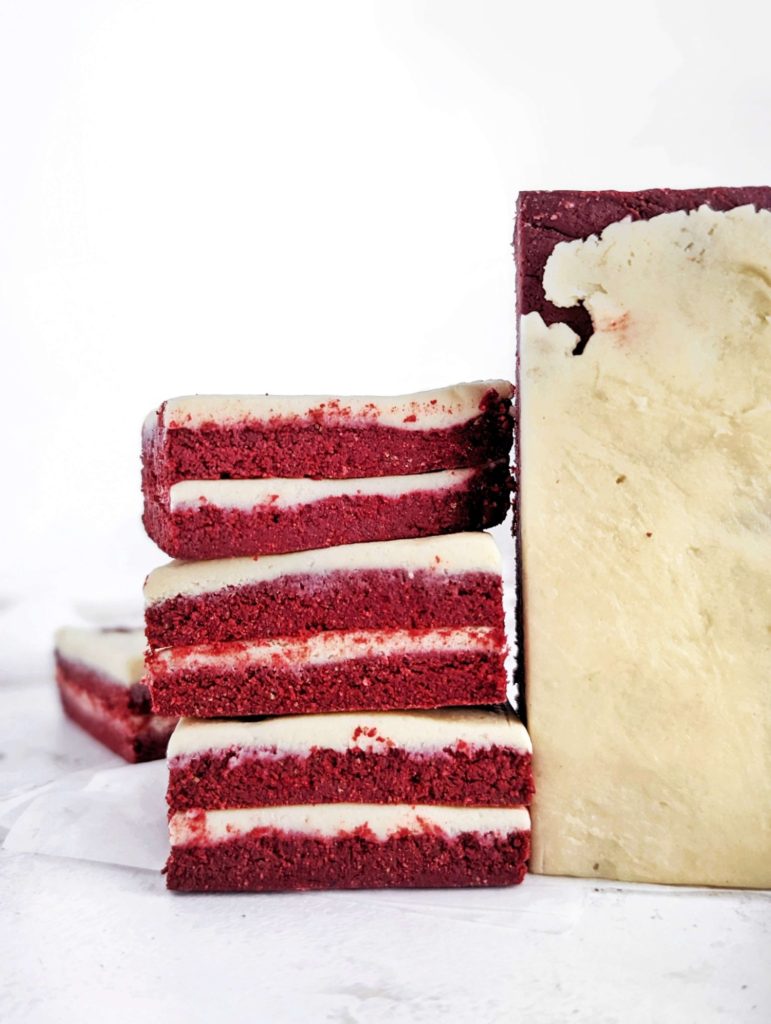 Pretty and perfect Red Velvet Protein Bars complete with layers and a protein cream cheese ‘frosting’! These no bake red velvet bars use protein powder and greek yogurt for a sugar free, low fat and healthy recipe.