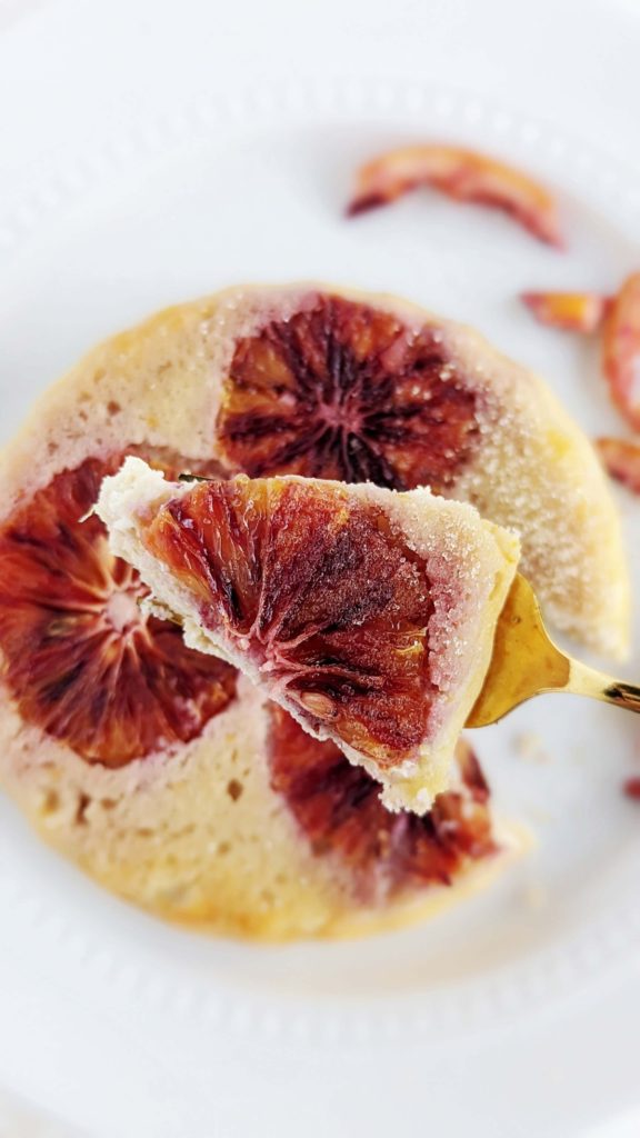 Beautiful Blood Orange Protein Cake for one made with a ton of protein powder and egg whites! This healthy blood orange mug cake is just like the upside down cake, but actually easy and has no sugar either.