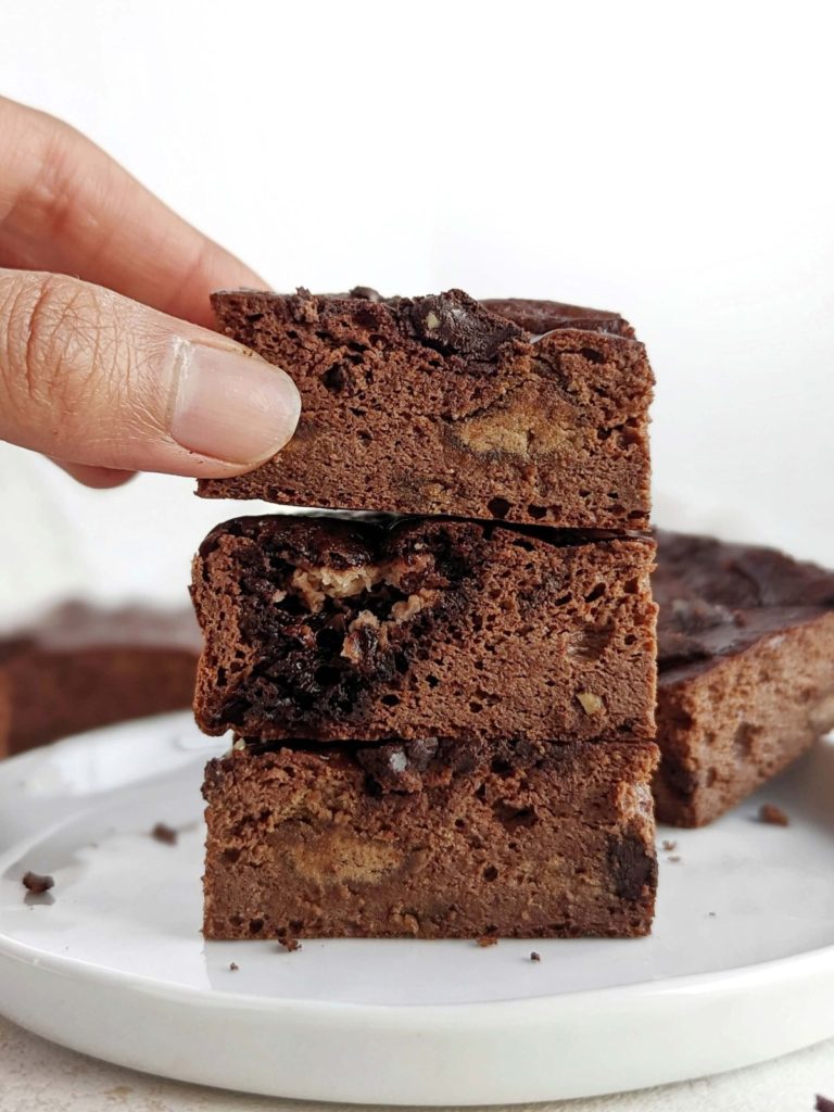 Just amazing Fudgy Protein Brownies that are actually healthy and low calorie! These fudgy chocolate protein brownies use protein powder, monk fruit, almond butter and sugar free melted chocolate; No sugar, butter or oil needed!