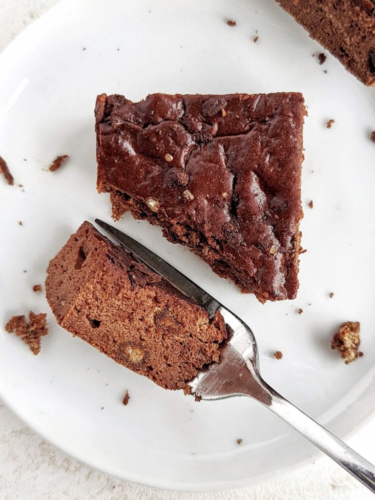 Just amazing Fudgy Protein Brownies that are actually healthy and low calorie! These fudgy chocolate protein brownies use protein powder, monk fruit, almond butter and sugar free melted chocolate; No sugar, butter or oil needed!