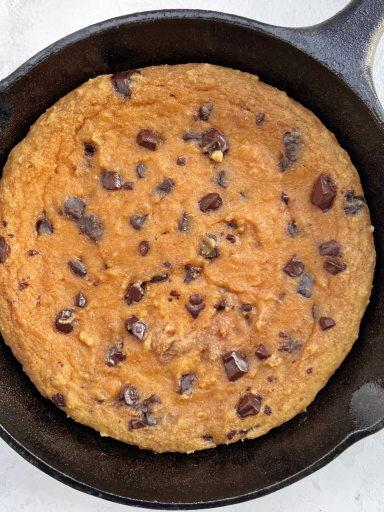 A truly extremely easy Chocolate Chip Protein Skillet Cookie made with a few healthy ingredients. This chocolate chip protein cookie uses applesauce, almond butter and protein powder, has no sugar and is quite a low calorie recipe!