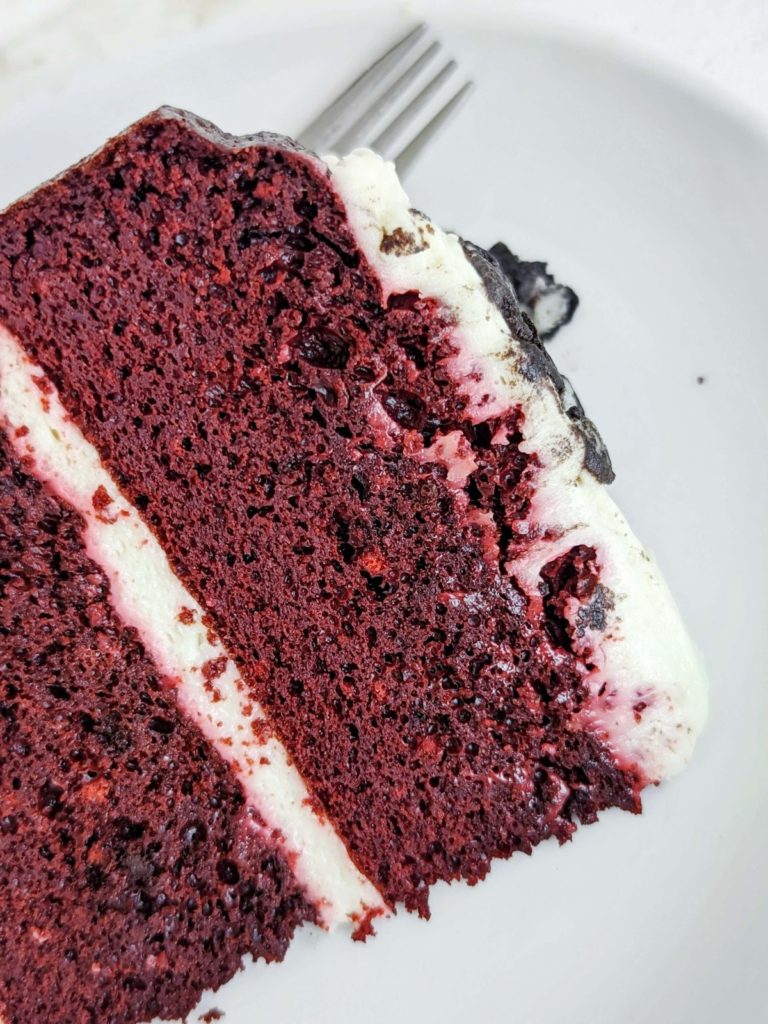 Amazing Protein Red Velvet Cake topped with a Greek yogurt and cream cheese frosting - truly the only one you will want. A high protein healthy red velvet cake sweetened with chocolate protein powder, and barely any fat - the ideal protein dessert!