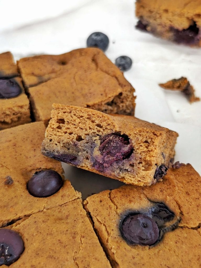 Sweet and spiced Blueberry Pumpkin Protein Bars perfect for a cozy snack, dessert or post-workout treat! Healthy blueberry pumpkin bars use protein powder for sweetener and are low-sugar and low fat too.