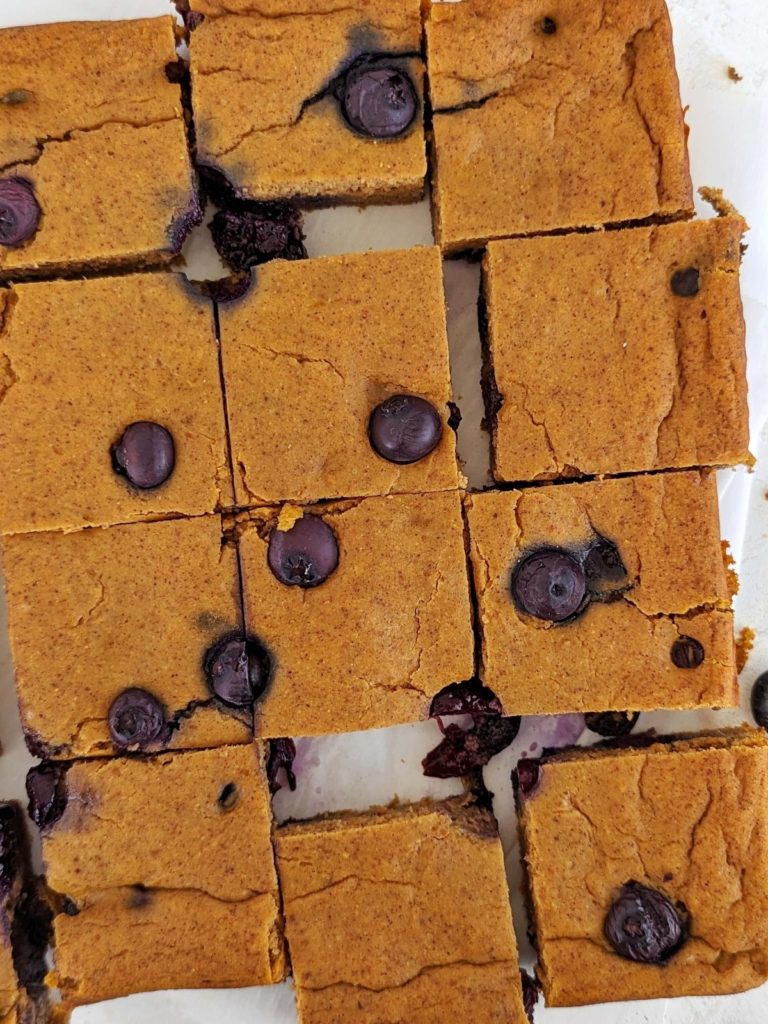 Sweet and spiced Blueberry Pumpkin Protein Bars perfect for a cozy snack, dessert or post-workout treat! Healthy blueberry pumpkin bars use protein powder for sweetener and are low-sugar and low fat too.