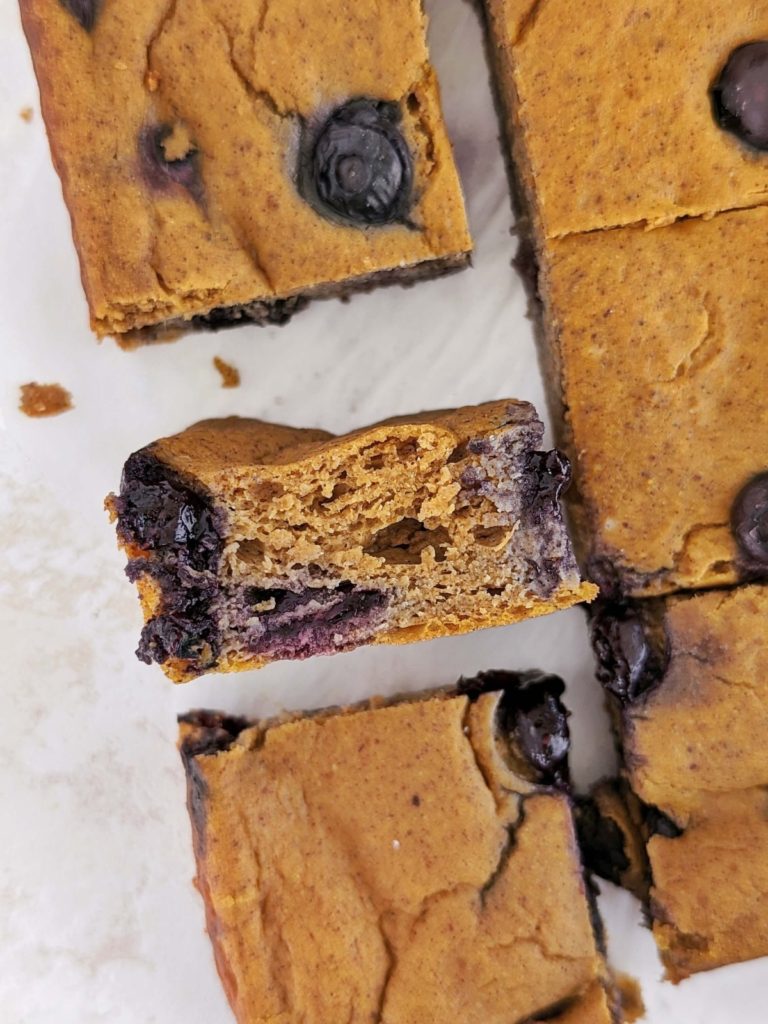 Sweet and spiced Blueberry Pumpkin Protein Bars perfect for a cozy snack, dessert or post-workout treat! Healthy blueberry pumpkin bars use protein powder for sweetener and are low-sugar and low fat too.