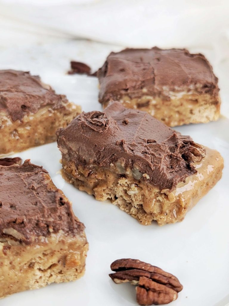 Ooey-gooey Turtle Protein Bars with layers of a caramel-y base, caramel, pecans and chocolate frosting, but all high protein and low sugar! Healthy chocolate caramel pecan turtle bars to satisfy those cravings.