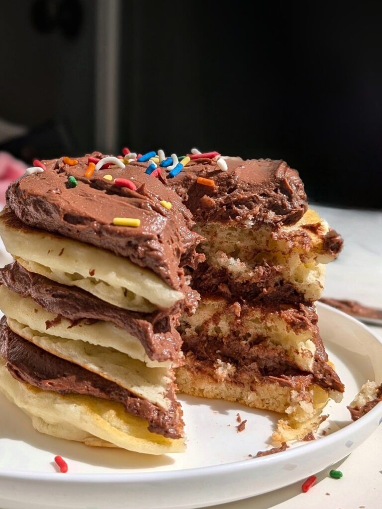 This easy Pancake Cake, made with fluffy protein buttermilk pancakes and topped with rich, low-sugar protein chocolate frosting, is the perfect breakfast, dessert or post-workout treat. And that too low in fat and calories with just 5 ingredients!