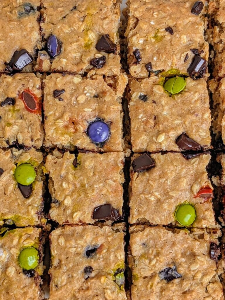 One-bowl Healthy Monster Cookie Bars packed with protein! These monster cookie baked oats are lower sugar and lower fat and perfect for a breakfast or post-workout snack.