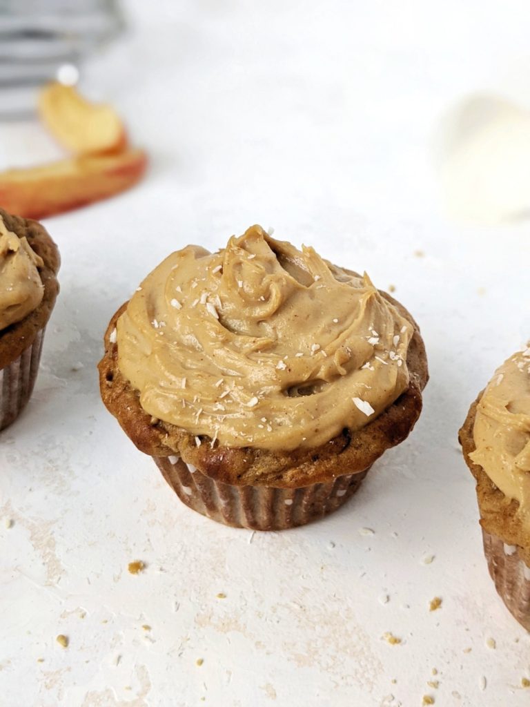 Easy and healthy Protein Apple Cupcakes topped with a Protein Peanut Butter frosting; Made with whole wheat flour, protein powder, greek yogurt and applesauce, these have no oil and are sugar free too! Pipe on some high protein peanut butter frosting and you have the perfect apple cupcake for breakfast or dessert!