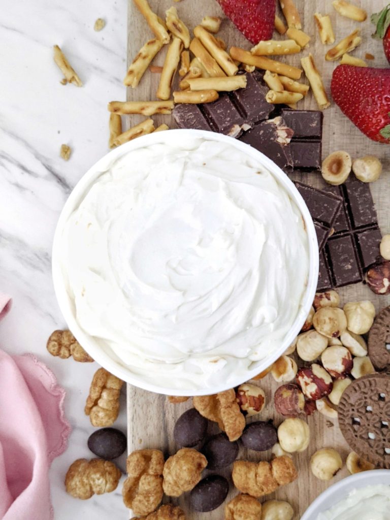 A truly easy and healthy Protein Cheesecake Dip with Greek Yogurt and protein powder, but no powdered sugar! 3 ingredient cheesecake dip is like a deconstructed cheesecake and a perfect protein powder fruit dip for dessert.