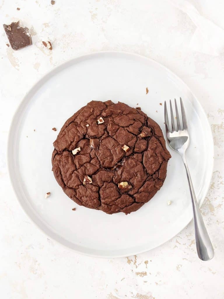 A giant Single Serving Chocolate Protein Cookie made with oat flour, greek yogurt and protein powder. This healthy single serve protein cookie is gluten free, sugar free, oil free and egg free; Easily Vegan and a great post workout treat or healthy dessert.