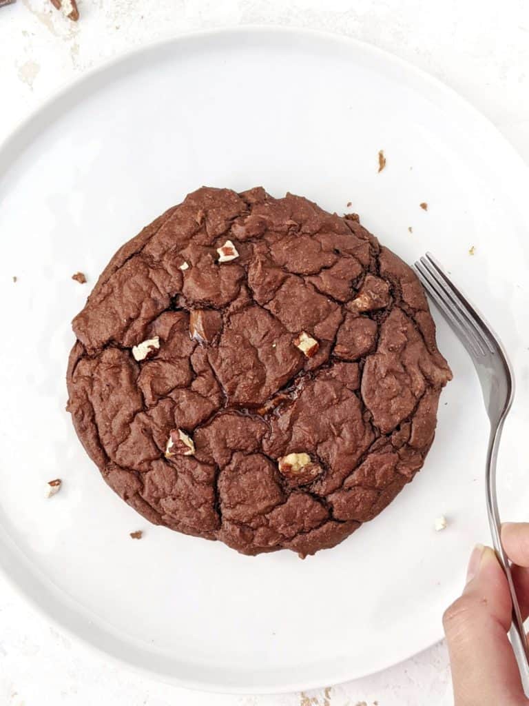 A giant Single Serving Chocolate Protein Cookie made with oat flour, greek yogurt and protein powder. This healthy single serve protein cookie is gluten free, sugar free, oil free and egg free; Easily Vegan and a great post workout treat or healthy dessert.