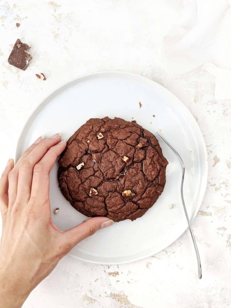 A giant Single Serving Chocolate Protein Cookie made with oat flour, greek yogurt and protein powder. This healthy single serve protein cookie is gluten free, sugar free, oil free and egg free; Easily Vegan and a great post workout treat or healthy dessert.