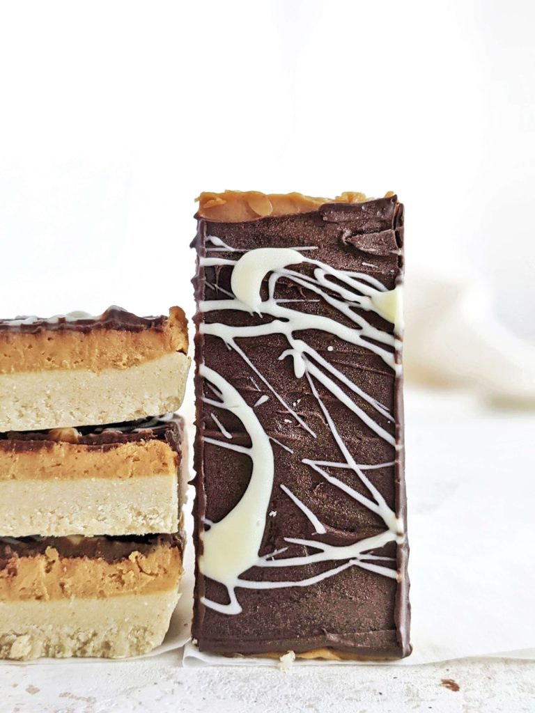 Amazing Protein Millionaire Shortbread bars made low calorie with protein powder and peanut butter, with no condensed milk. These healthy millionaire shortbread protein bars are perfect for a homemade snack or dessert; Vegan too!