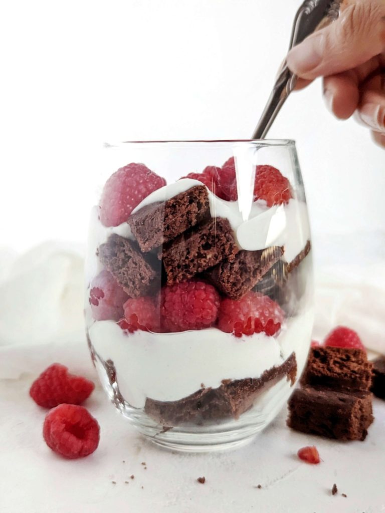 An easy and beautiful Chocolate Raspberry Protein Trifle with protein brownies, a Greek yogurt ‘custard’ and fresh raspberries. This healthy raspberry brownie trifle is sugar free, gluten free and Vegan too!