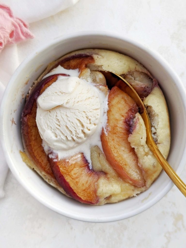 The perfect high Protein Peach Mug Cake with a ton of protein powder and egg whites, and no sugar or butter. Healthy peach mug cake is gluten free, low carb, and easily vegan too!